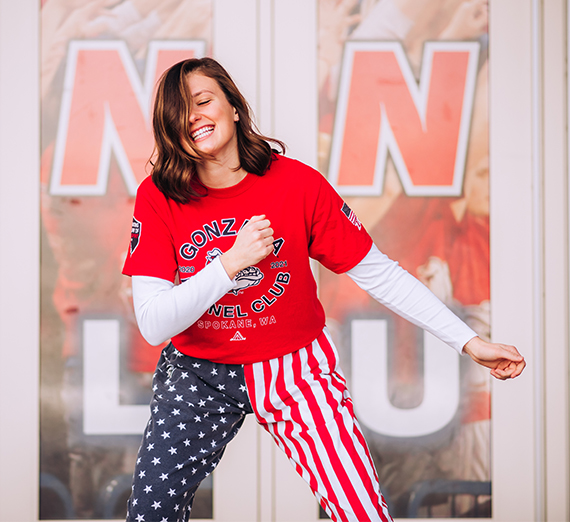 female dressed in kennel club attire dances in front of Kennel doors