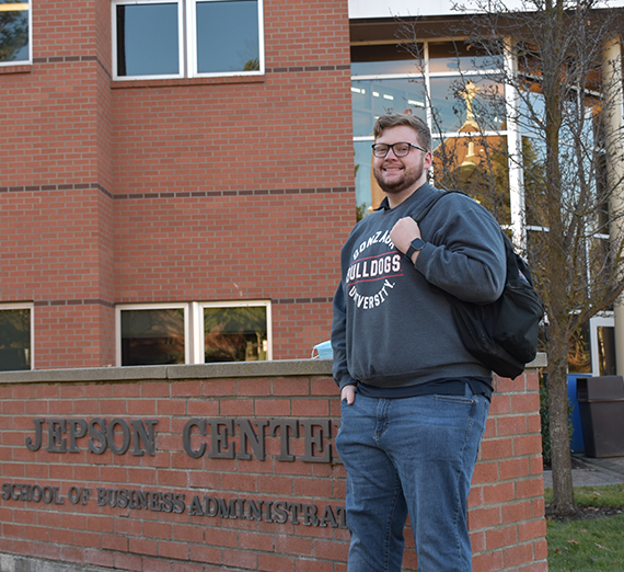 Richard poses in front of the Jepson Center sign