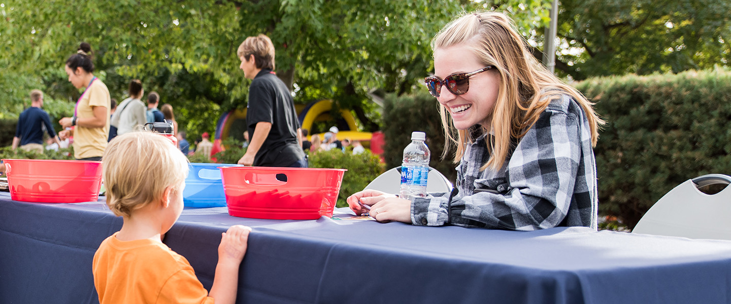 Student volunteering at neighborhood block party 