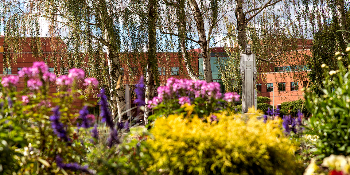 aluminum Jesus surrounded by spring flowers